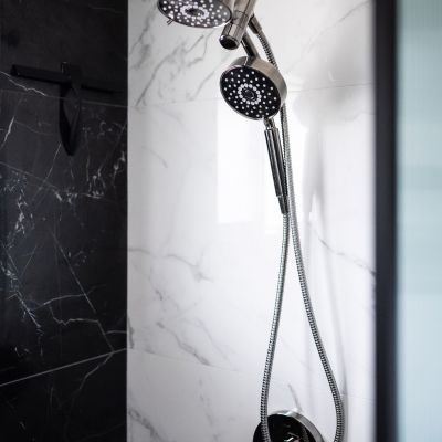 shower head in black and white tile shower remodel
